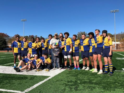 Emory & Henry College Rugby posing with the Cardinal Collegiate Conference tournament trophy after defeating William and Mary, 62-37.
