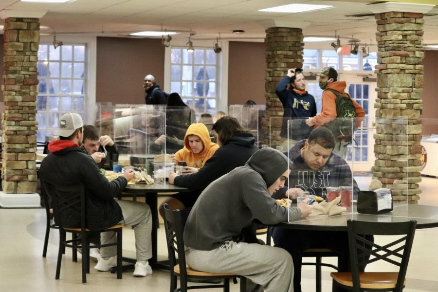 The Caf now has plexiglass on tables so that students can eat in-person.