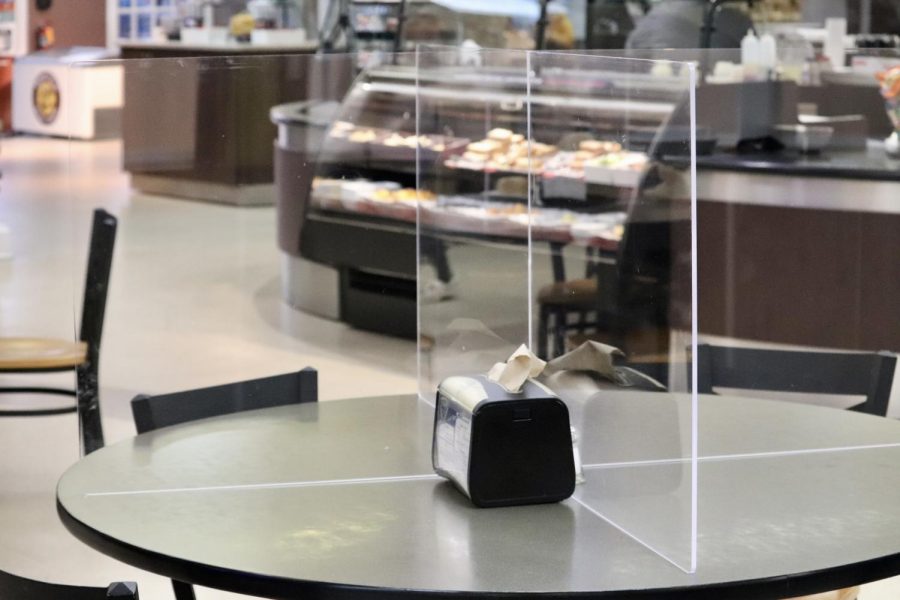 The Caf now has plexiglass on tables so that students can eat in-person.